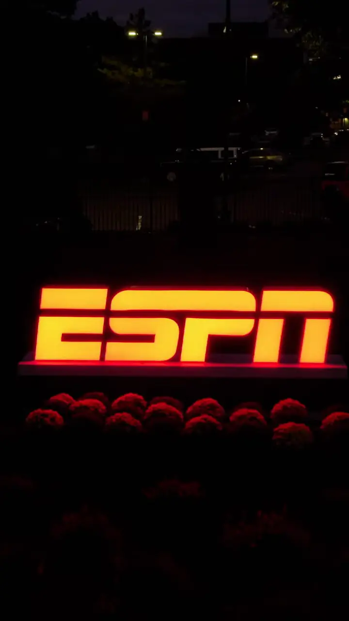 The illuminated red ESPN monument sign at night