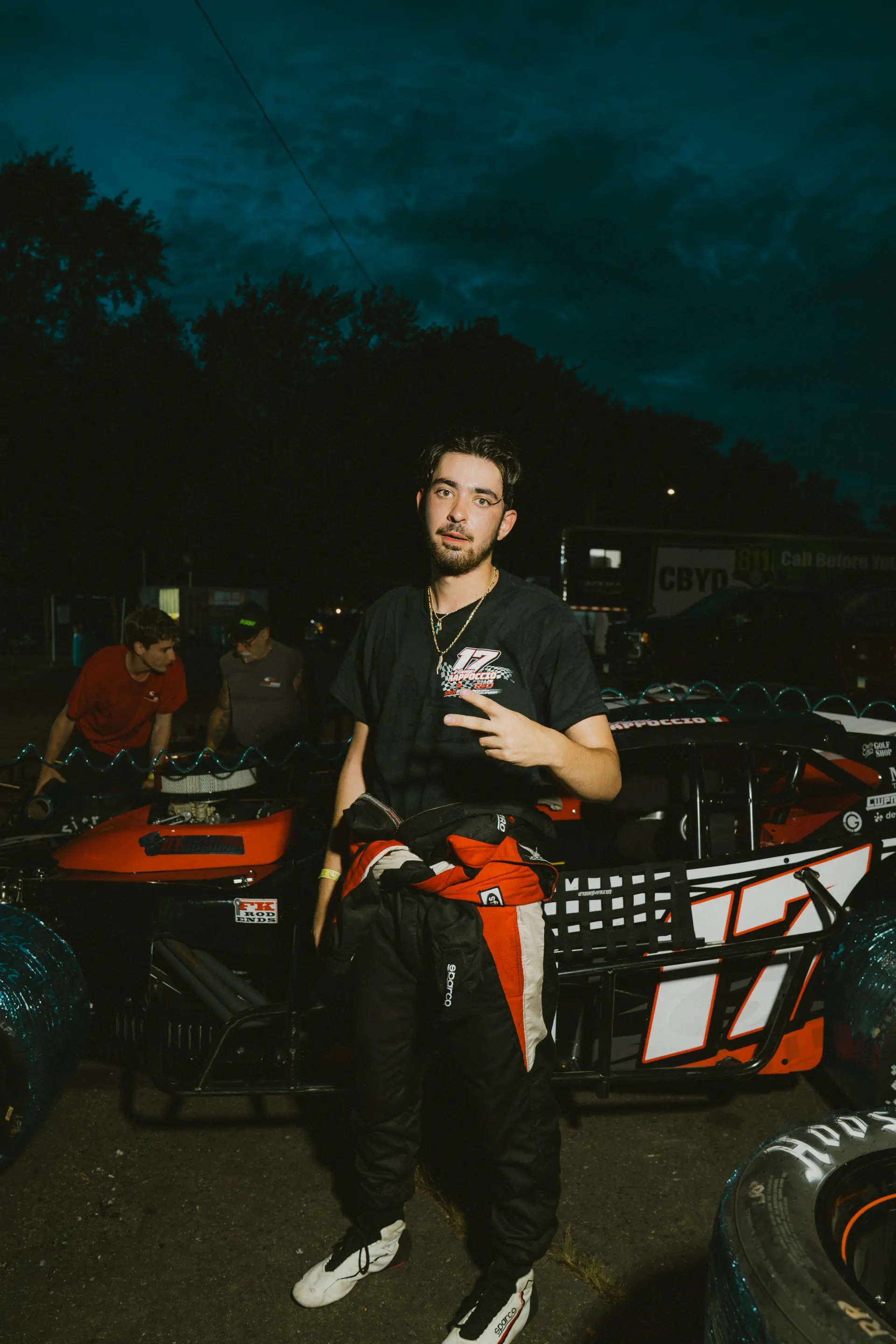 Vinny Rappoccio beside the number 17 car at dusk